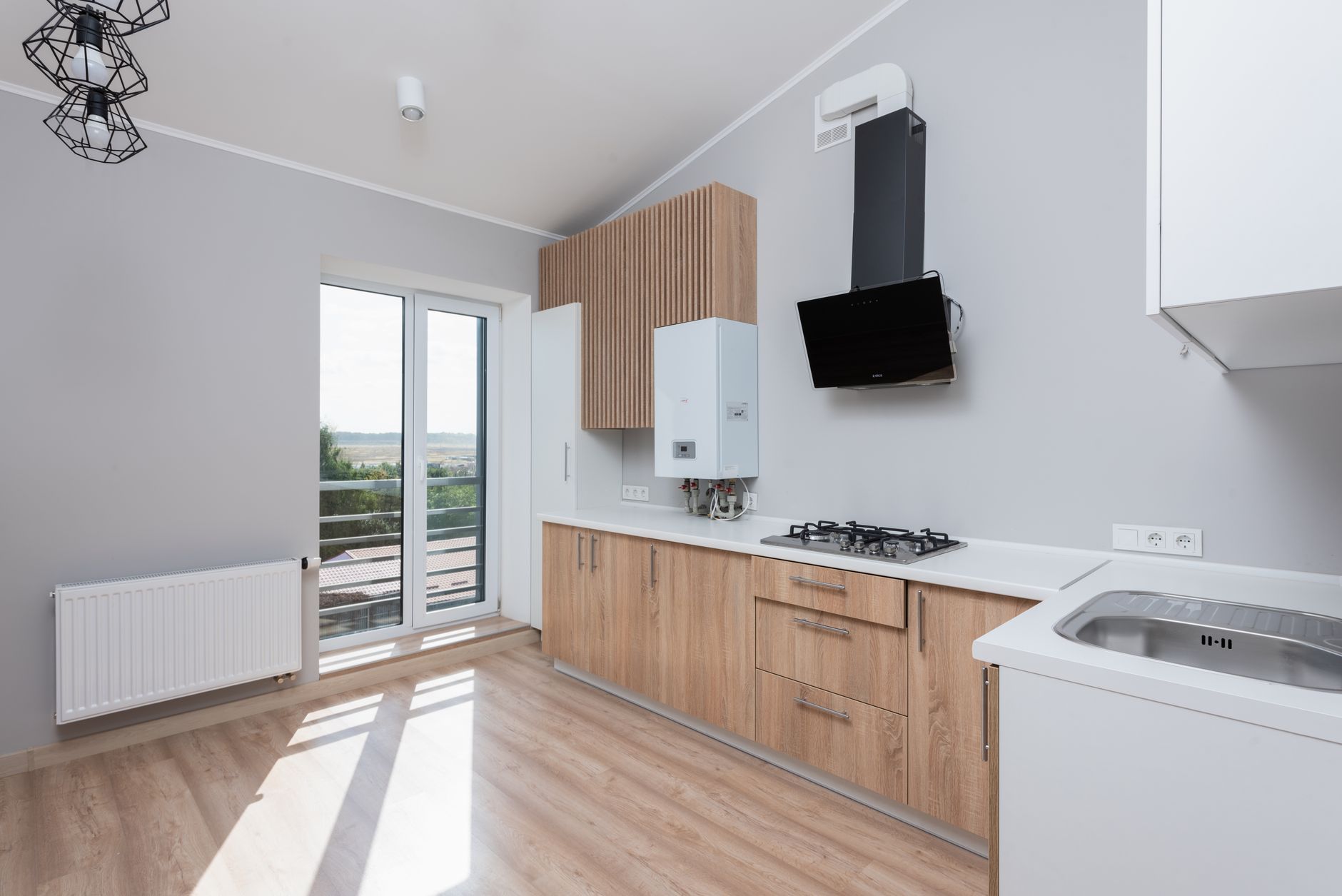 Stylish empty kitchen with wooden cabinets and large windows in Yakima, WA
